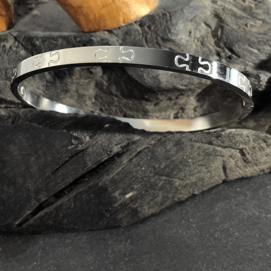 Stainless Steel Bangle Silver Coloured Oval with Jigsaw Motif